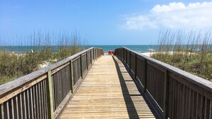 A wooden boardwalk leading to a beach with clear skies. - Beach and Tennis Resort Villa (Hilton Head Island)