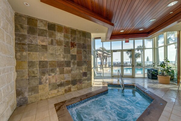 Relax by the serene pool surrounded by a mosaic tile design and natural views.