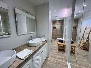 A modern bathroom with a large mirror, two sinks, and a shower area. - Mas Fumats house with pool, terrace and garage AV 49 (Rosas / Roses)
