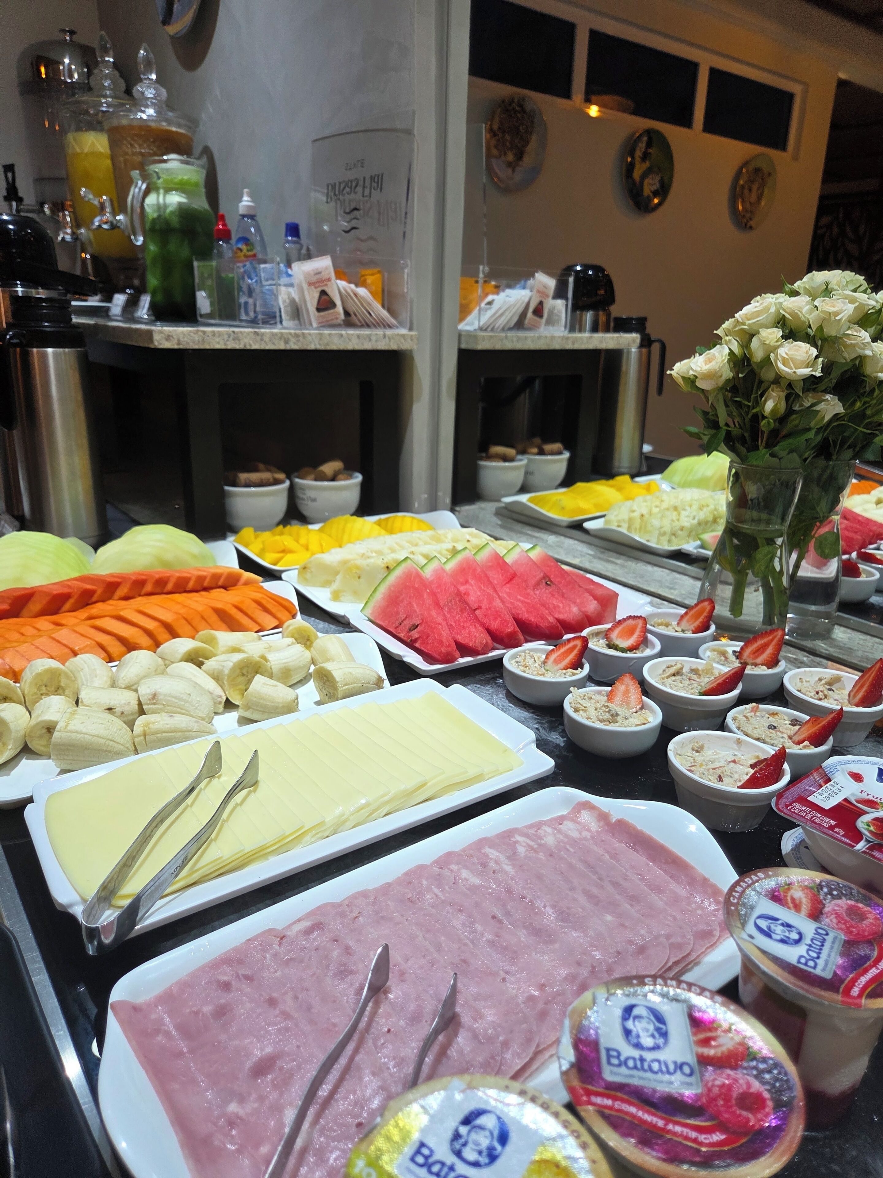 A buffet with various food items, including fruits, vegetables, and meats.