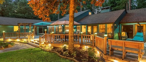 A row of cabins with outdoor seating and a well-lit deck area.