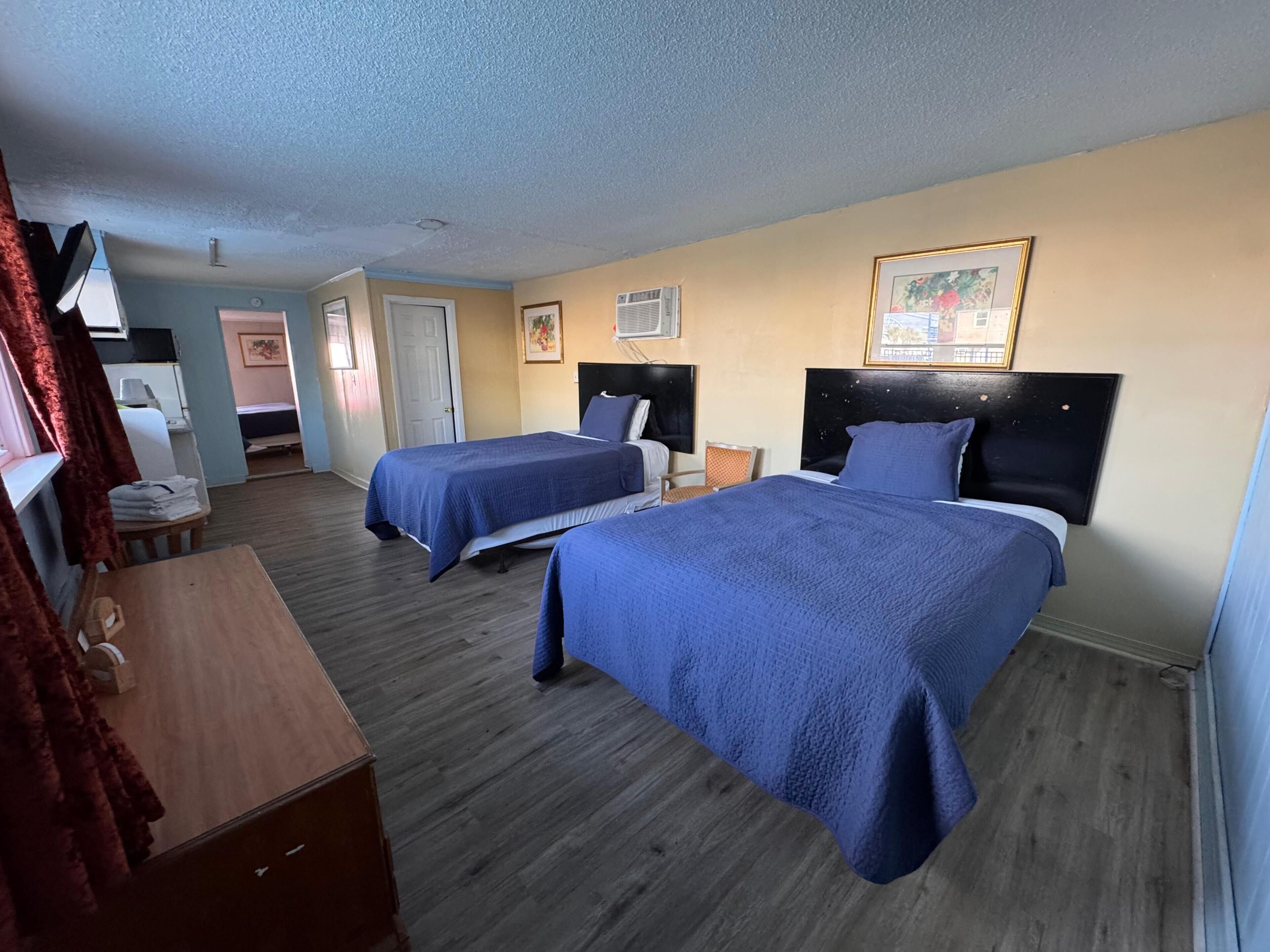 Family Room, 2 Bedrooms, Non Smoking (1 King & 2 Double Beds) | Desk, bed sheets