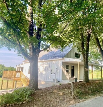 Front of Home with Covered porch and Seating for 9 and game table