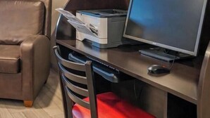 A workspace with a desk, computer, printer, and a chair. - Cozy 1-bedroom hotel in delightful Huntersville up to 2 people (Huntersville)