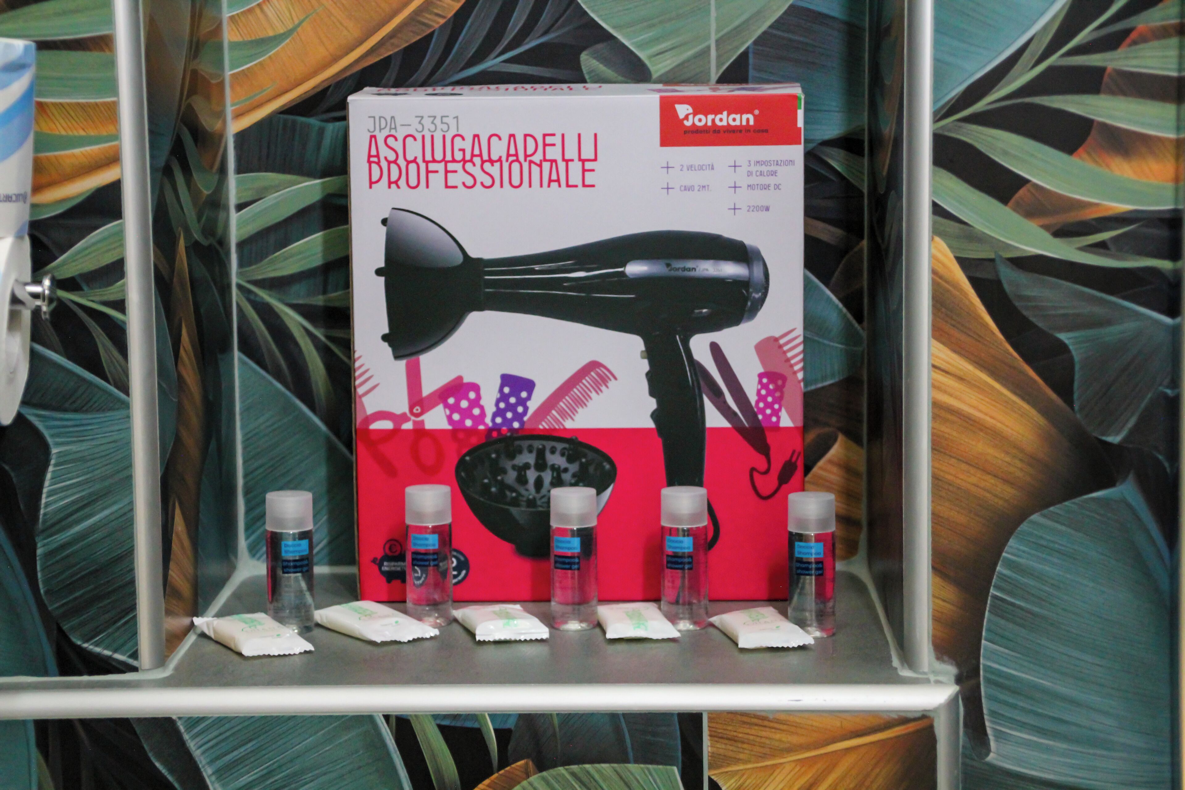 A hairdryer and its accessories on a shelf.