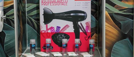 A hairdryer and its accessories on a shelf.