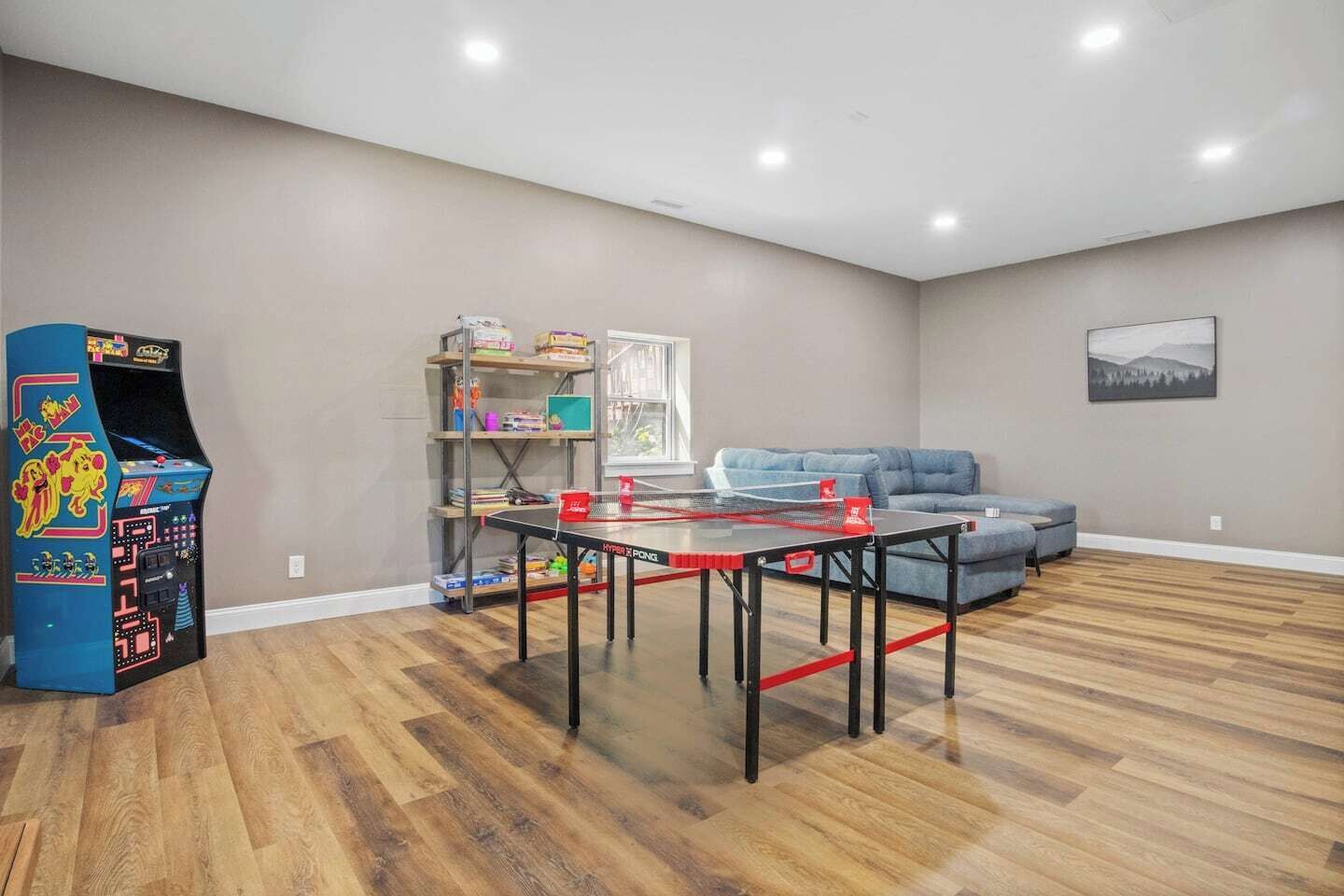 Gamers paradise with 4 person ping pong table, Pacman arcade, board games and books