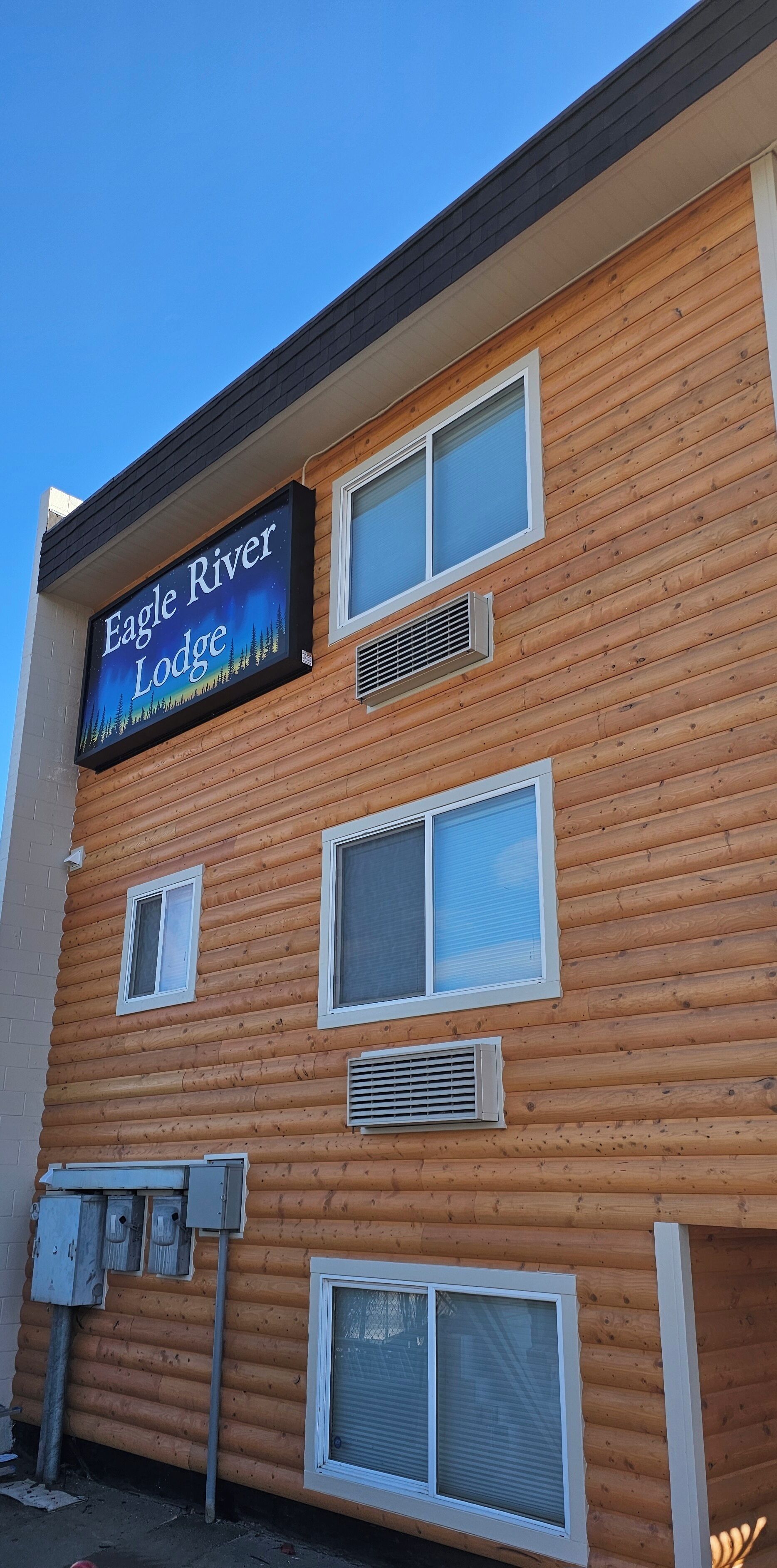 A multi-story lodge with a prominent sign reading "Eagle River Lodge".