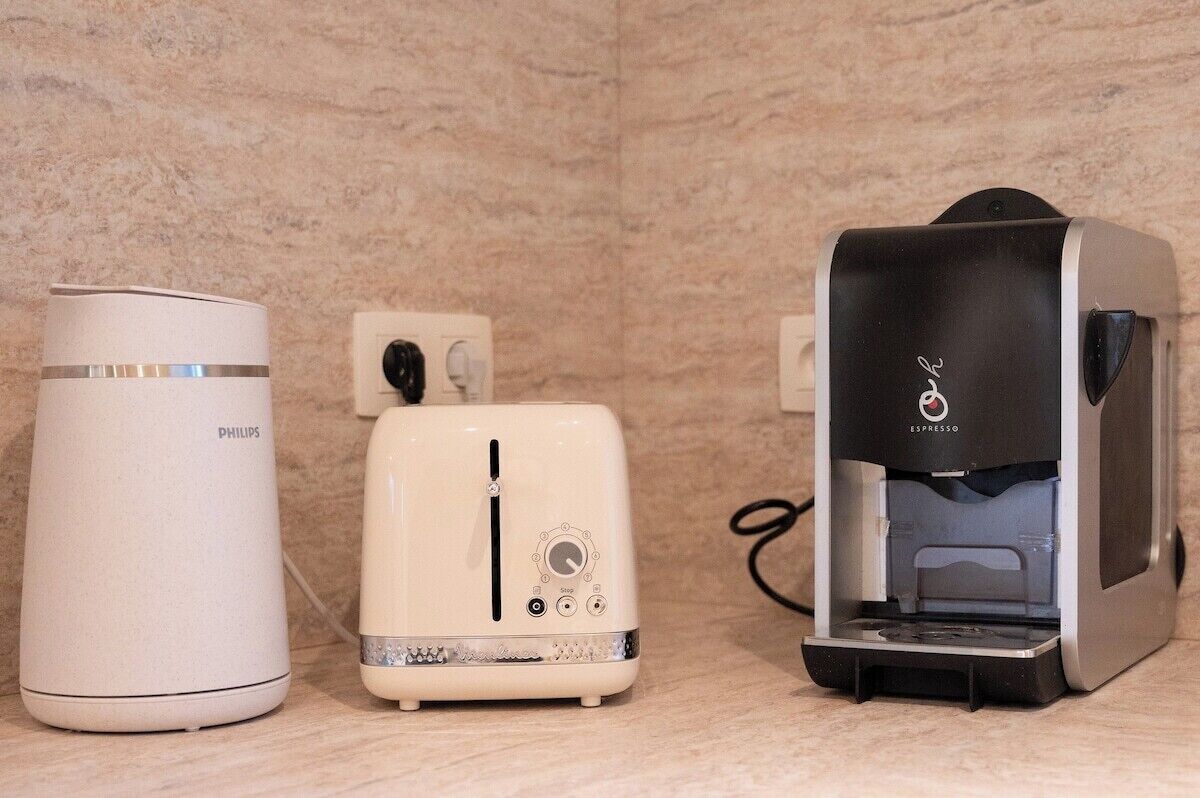 Three kitchen appliances: a Philips coffee maker, a Philips toaster, and a Philips electric kettle.