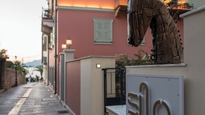 A street view with a building labeled "ELLO LUXURY ROOMS".