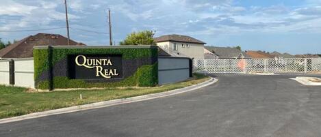 A residential area with a sign for 'Quinta Real' and a gated entrance.