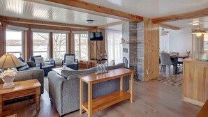 A spacious living area with a sofa, a wooden coffee table, and a television.