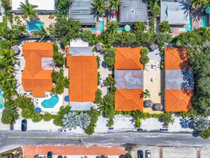 An aerial view of a resort with multiple buildings, each with a distinct roof design.