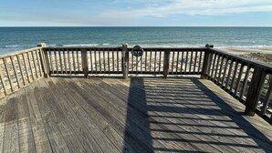 Una pasarela de madera que conduce a una playa con vista despejada al océano.