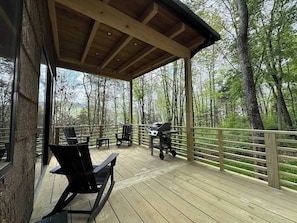 An outdoor deck with wooden flooring, a grill, and seating areas. - Luxury, 3.5 mi from VT, Private (Blacksburg)