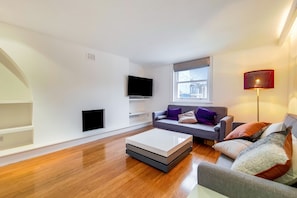Superior Apartment | Living area | 40-inch Smart TV with digital channels