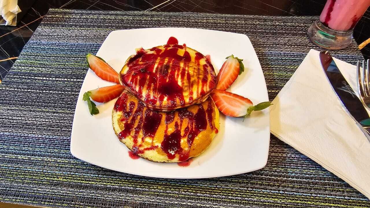 A plate with a dessert on a textured tablecloth.