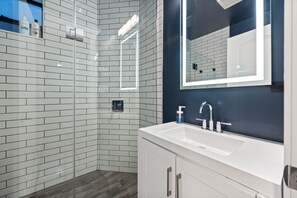 Shower, rainfall showerhead, hair dryer, towels