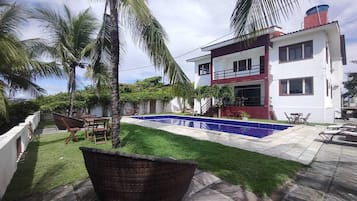 Enjoy a relaxing stay in this two-story home with a lawn, swimming pool, and outdoor seating areas.