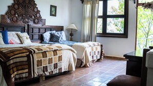 A bedroom with two beds, a wooden headboard, a nightstand, a lamp, and a window with curtains. - HOTEL SOLACHE INN (Zitácuaro)