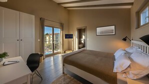 A bedroom with a bed, a desk, a chair, a window, and a door leading to a balcony. - Villa & Jardin - Luxury Villa with swimming pool (Vrh)