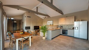 A modern kitchen with a central island, wooden cabinets, and a built-in oven. - Villa & Jardin - Luxury Villa with swimming pool (Vrh)
