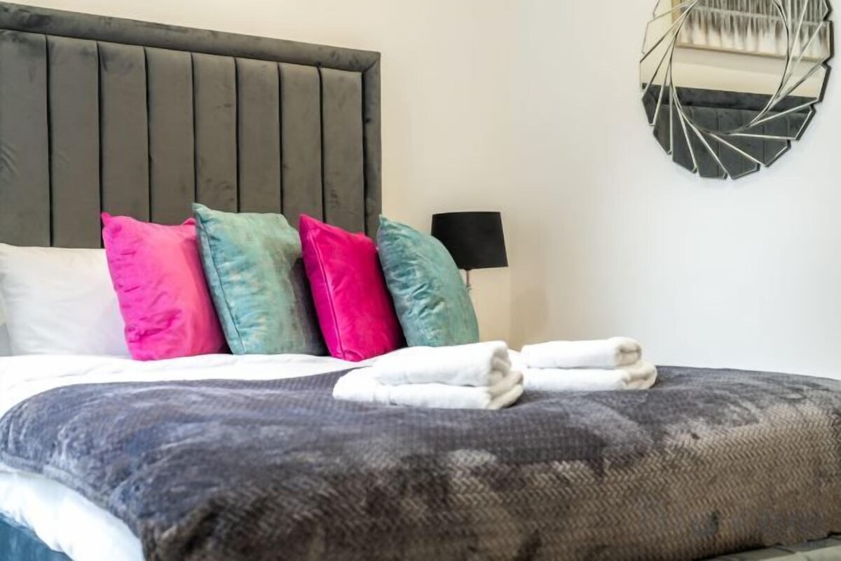 Laptop workspace, blackout curtains, iron/ironing board, bed sheets