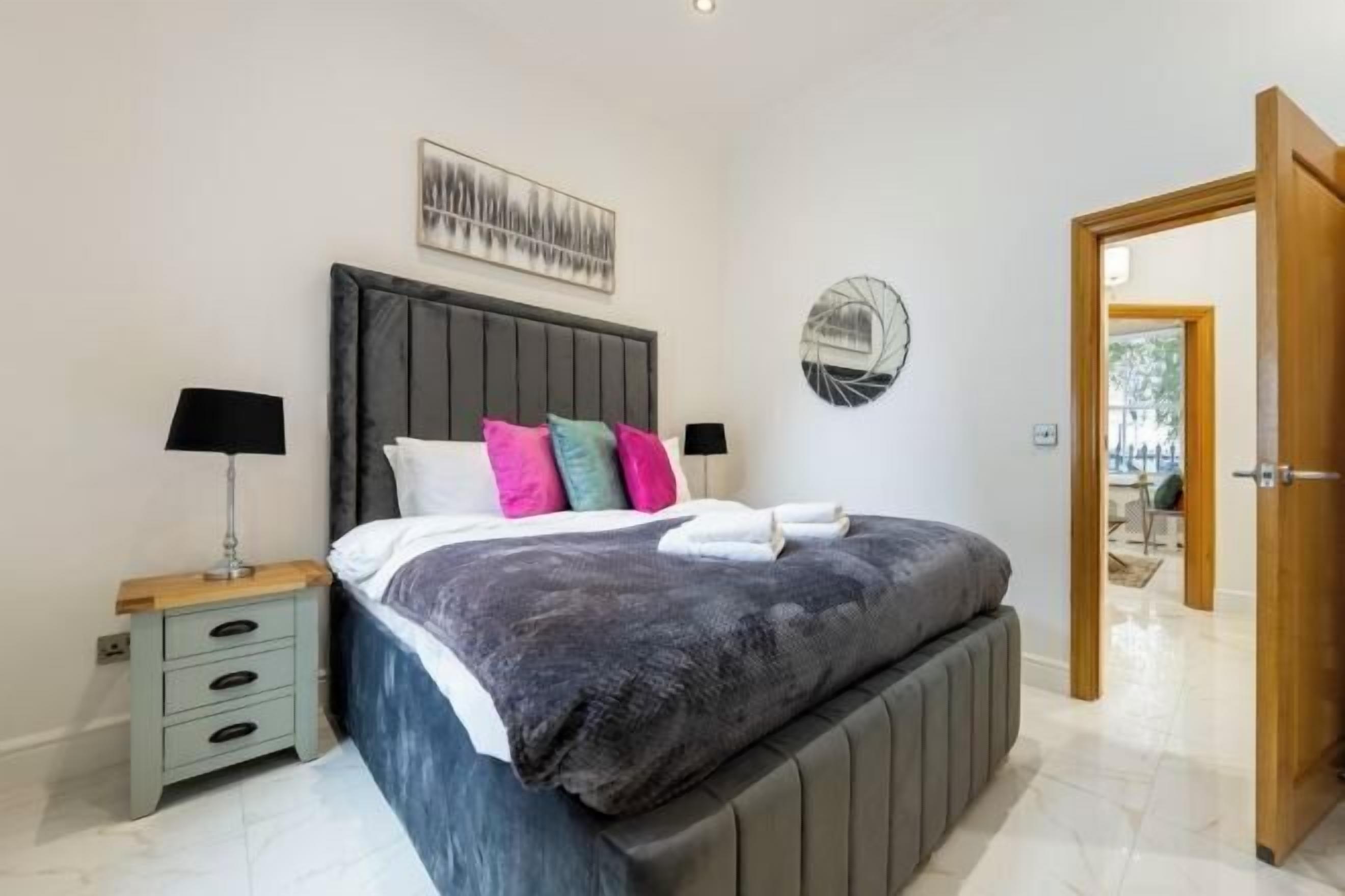 Laptop workspace, blackout curtains, iron/ironing board, bed sheets