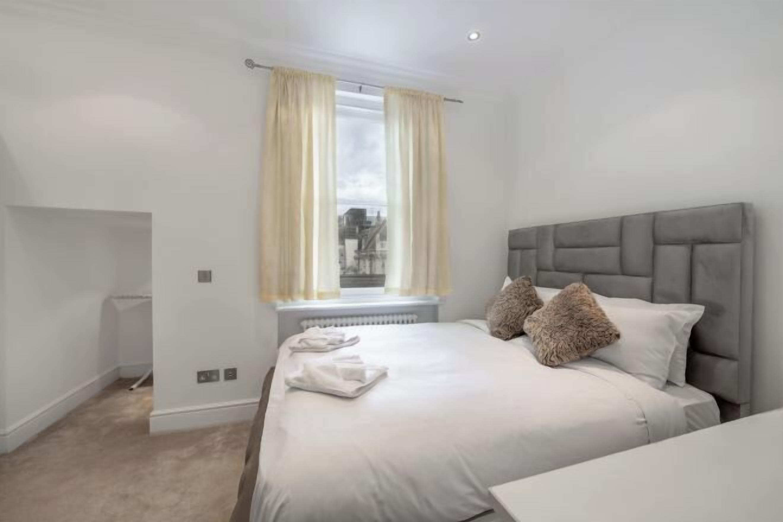 Laptop workspace, blackout curtains, iron/ironing board, bed sheets