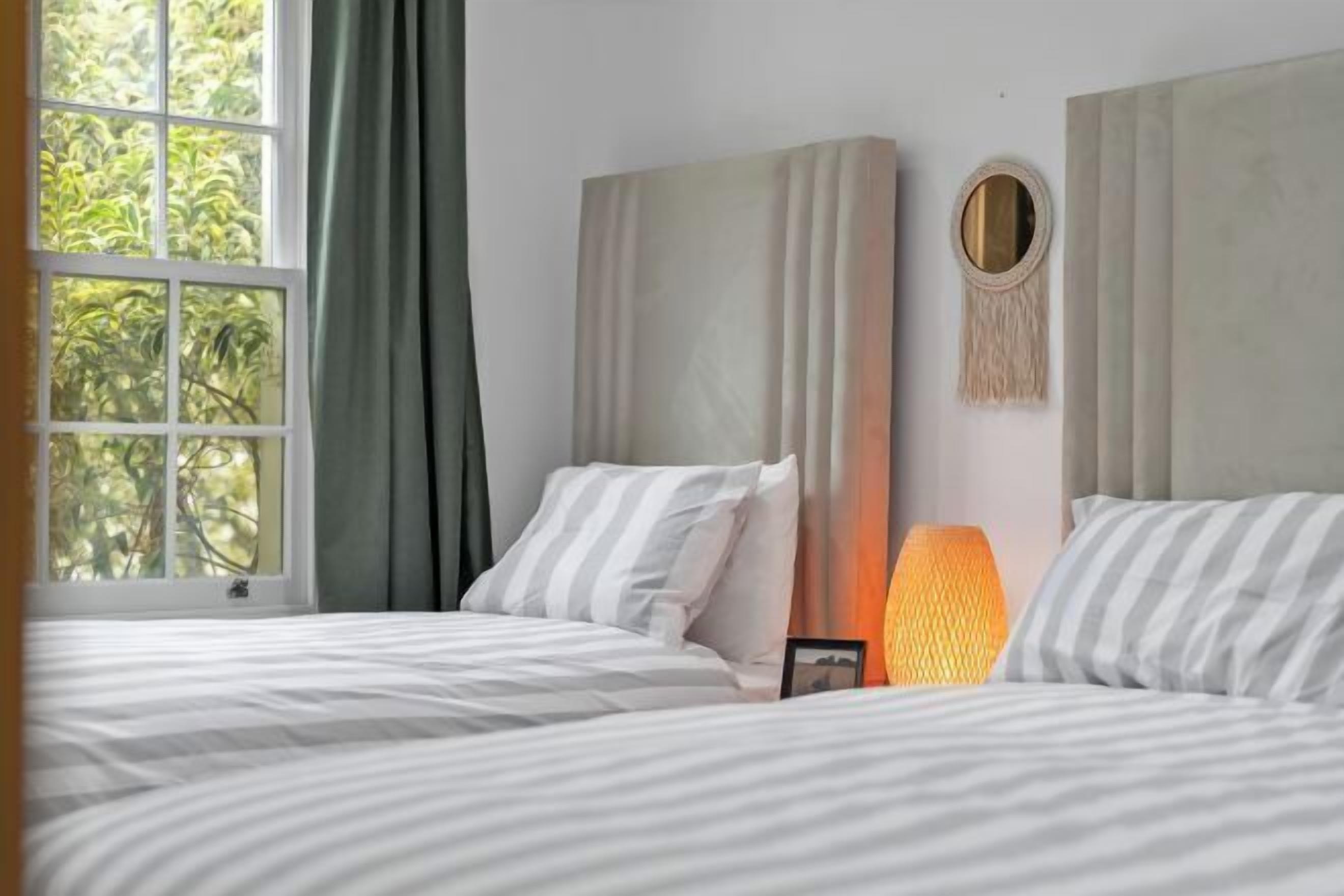 Laptop workspace, blackout curtains, iron/ironing board, bed sheets