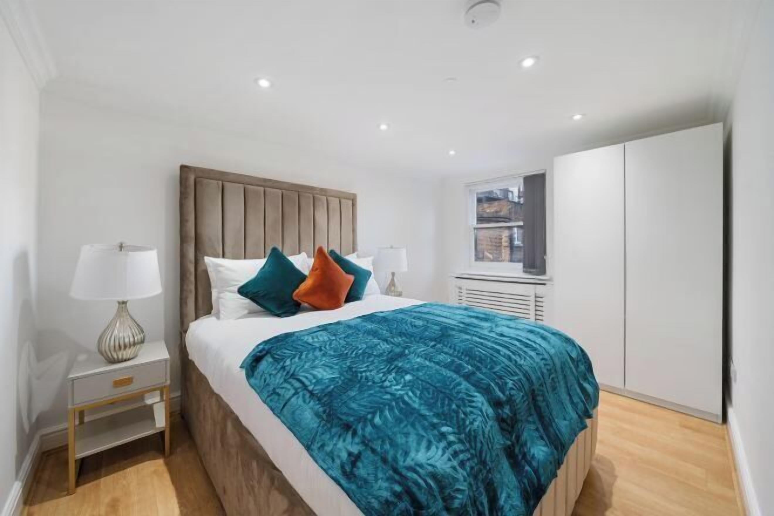 Laptop workspace, blackout curtains, iron/ironing board, bed sheets