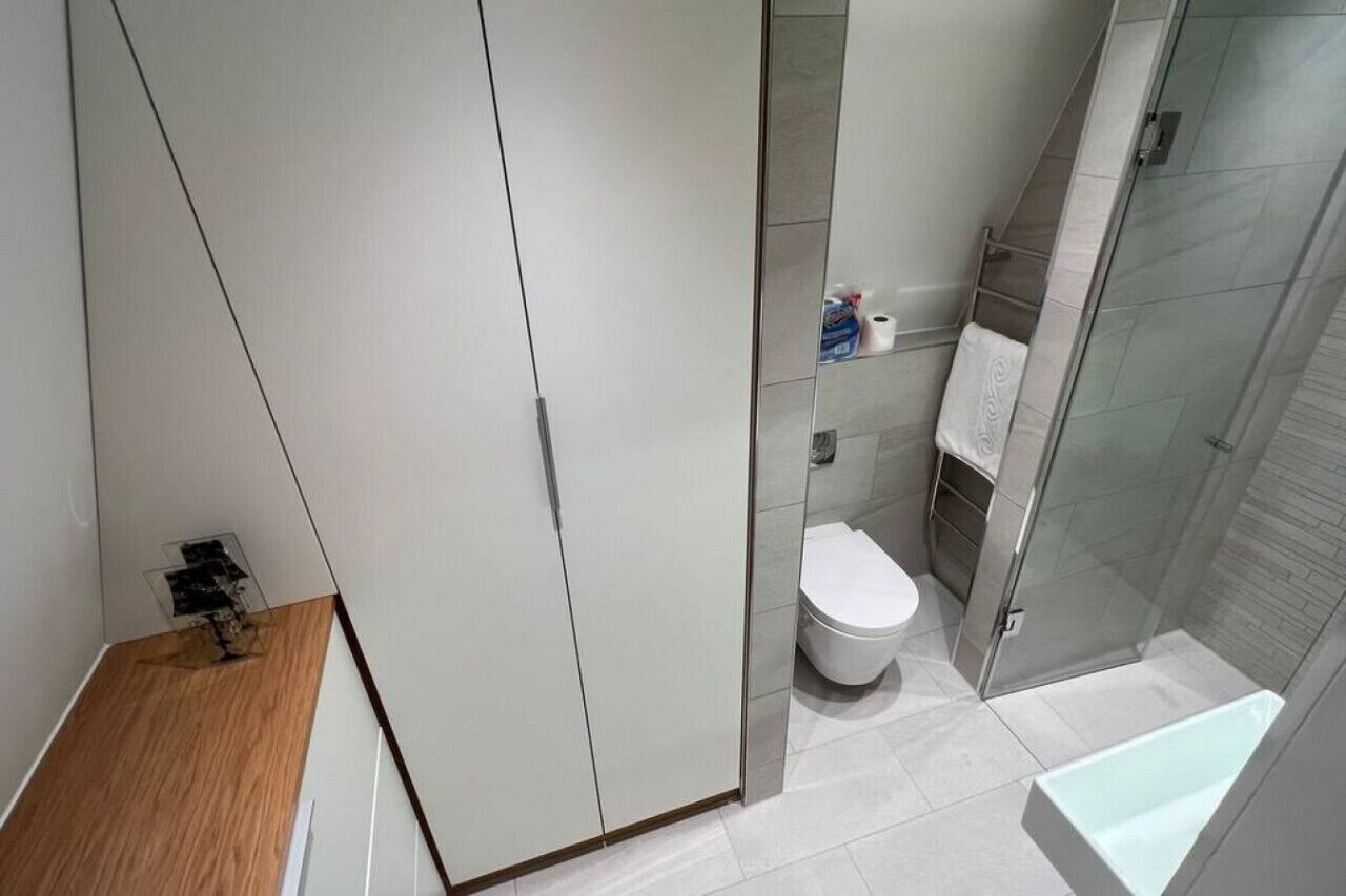 A modern bathroom with a toilet, shower, and a bathtub.