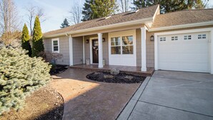 A two-story house with a front porch, a garage, and a driveway. - New! Charming Home in the Heart of Bemus Point, Lake Chautauqua, NY (Bemus Point)