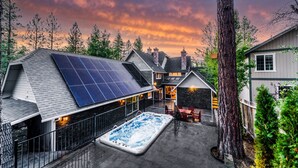 A residential property with a solar panel, a swimming pool, and a stone fireplace. - Bears Palace Chalet #2008 (Big Bear Lake)