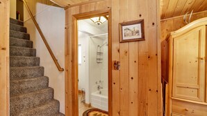 A wooden staircase leading to a bathroom with a bathtub and a shower. - Moonridge R N R #2320 (Big Bear Lake)