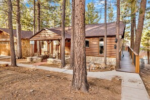 Escape to a serene forest retreat in this cozy cabin surrounded by tall pine trees.