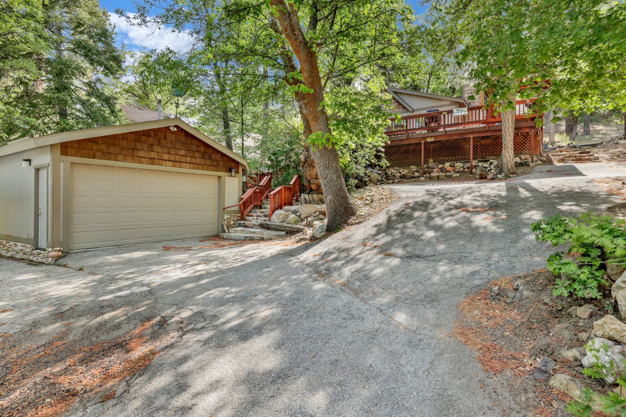 A two-story house with a garage and a covered porch.