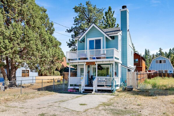 A two-story house with a balcony, a porch, and a chimney. - JAY Bird Landing Escape #2308 (Big Bear City)