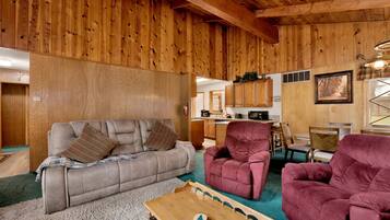 A cozy living room with a sofa, two armchairs, and a coffee table.