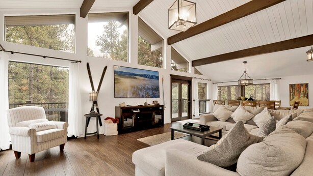 A spacious living room with a high ceiling, large windows, and a cozy seating area. - Soaring Pines #2193 (Big Bear Lake)