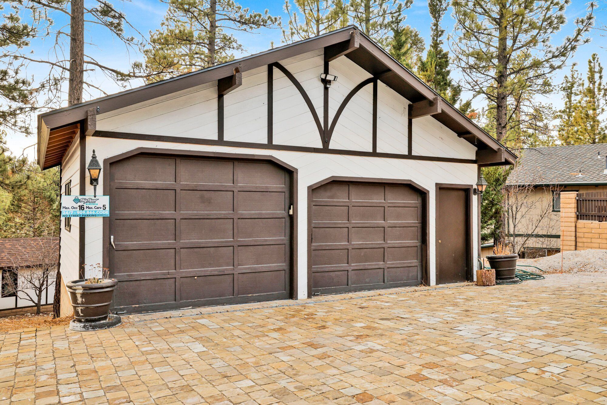 A two-car garage with a brown door and a white exterior.