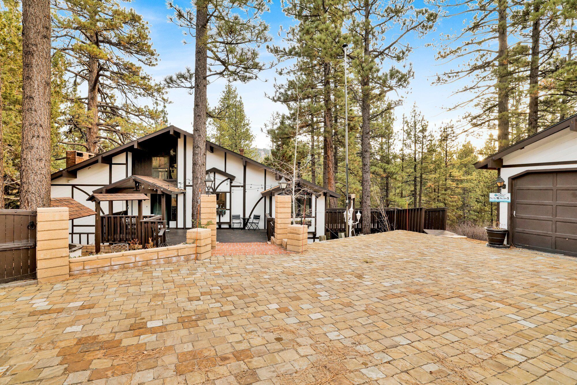 A two-story house with a covered patio and a garage.
