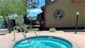 A swimming pool with a ladder, surrounded by a tiled deck. - Cienega Getaway #1952 (Big Bear Lake)
