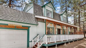 A lodge with a white garage, a covered porch, and a sign reading "Whiskey Mountain Lodge". - Whiskey Mountain Lodge - 2028 (Sugarloaf)