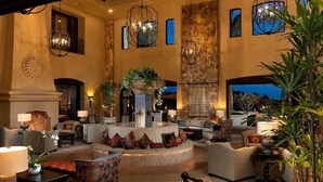 A spacious lobby with a central fountain, comfortable seating, and decorative lighting.