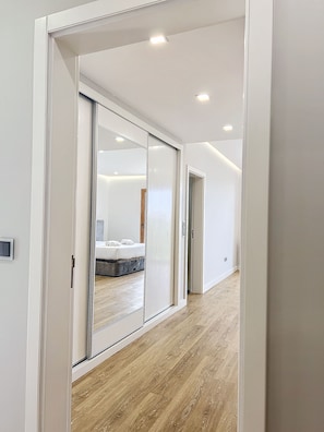 Relax in a serene space with a large sliding door leading to a bed and seating area.