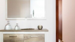 A bathroom with a white vanity, a mirror, and a window. - Charming Apartment & Diving La Restinga (La Restinga)