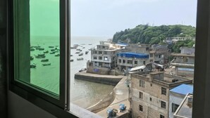 A coastal town with buildings, a harbor, and boats.