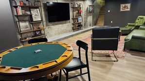 A room with a pool table, a television, and a staircase. - Gallant Fox - NuLu/Downtown (Louisville)