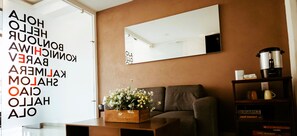 Relax in this stylish living room with a sofa, coffee table, and large window offering a view of the outdoors.